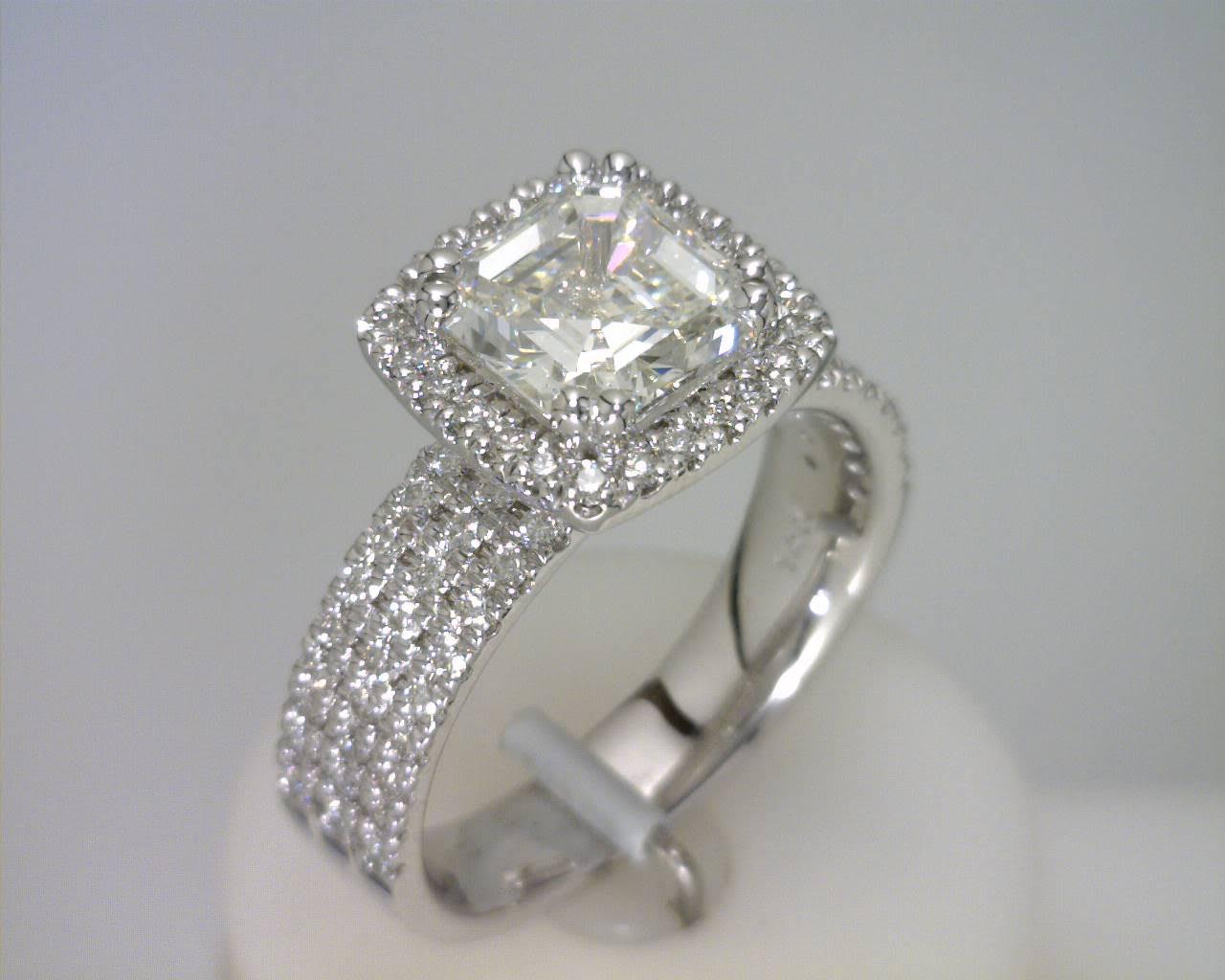 a custom ring with a square emerald cut center and diamond halo
