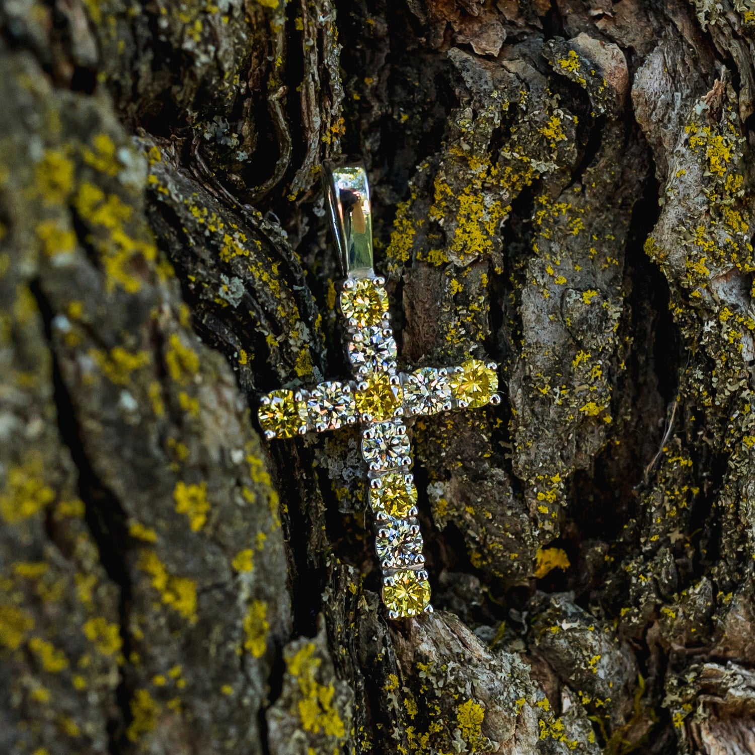 a custom-made cross pendant featuring white and yellow diamonds