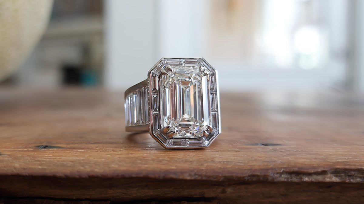custom ring with 8 carat emerald cut center and baguette halo