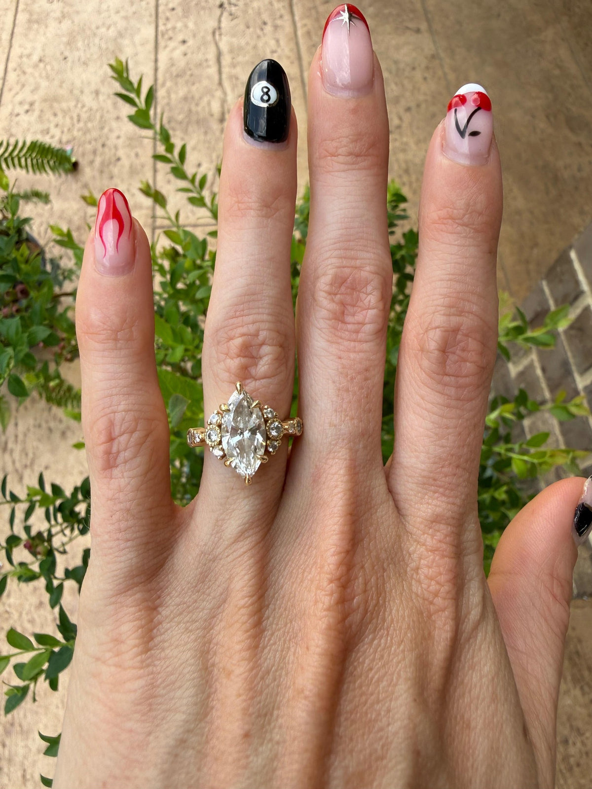 a photograph of a complete marquise cut ring on a hand