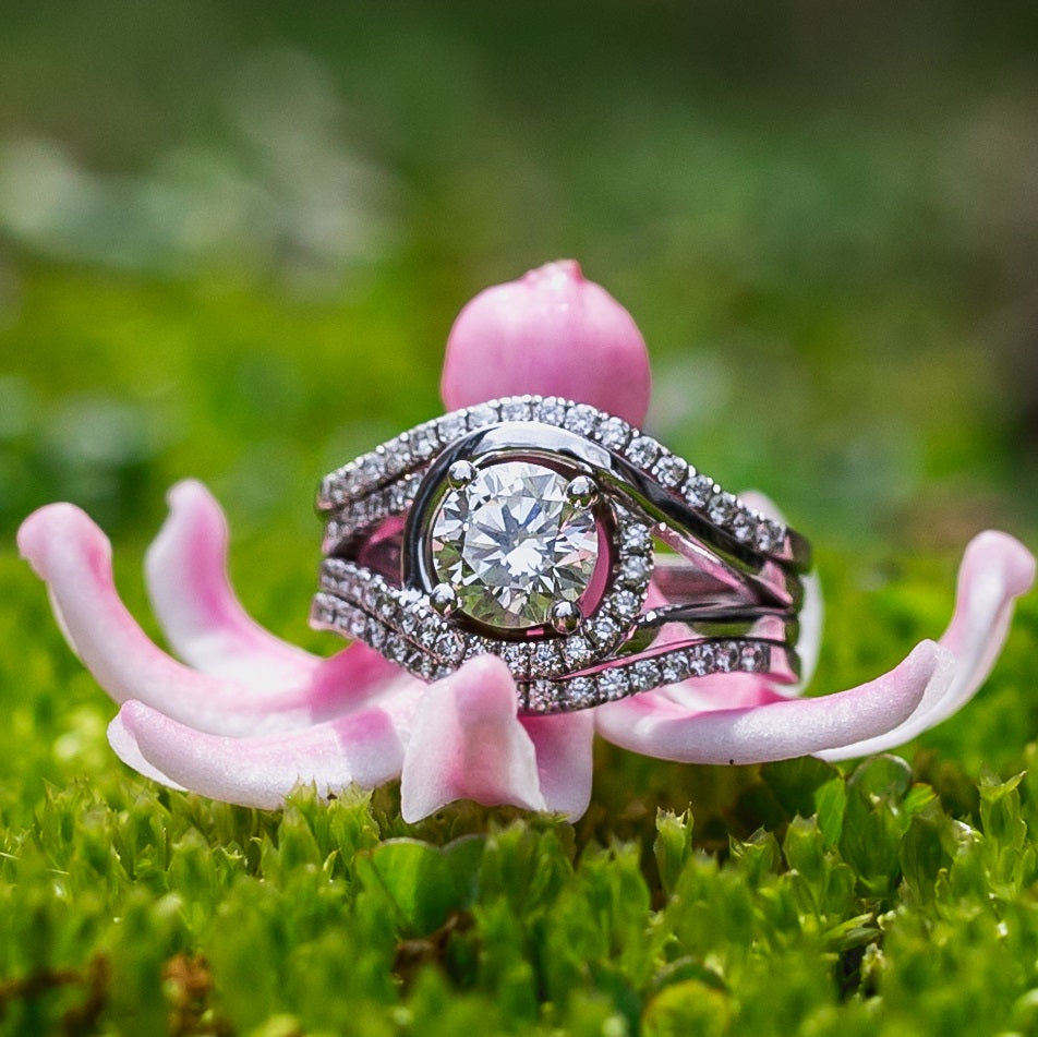 A swirly white gold ring on a flower